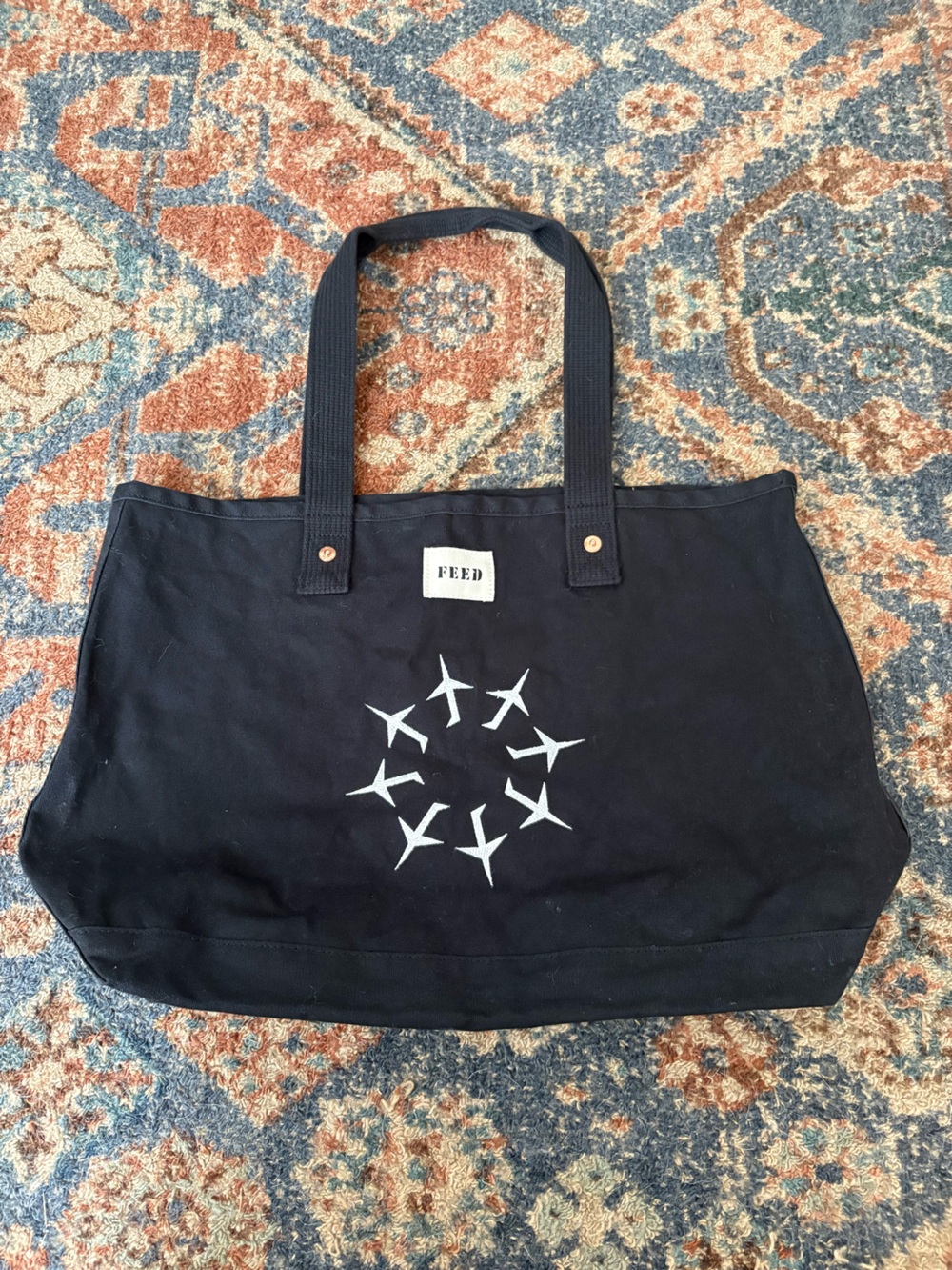 FEED Black Canvas Tote with Airplane Circle Graphic